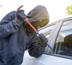 car theft - thief trying to break into the vehicle